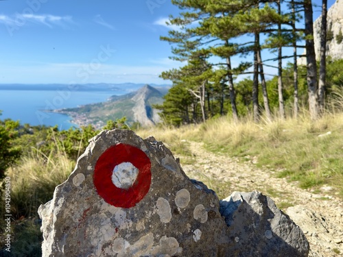 sign on a rock with view on Omiš croatia