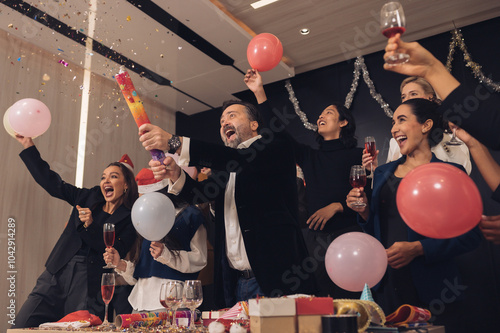 Christmas Day Businessman and business partners are successful, fun and happy at a group celebration party.