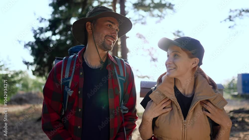 Portrait of happy male and female tourists walking together in forest, hiking. Athletic people spending weekend in nature, backpacking in woodland, medium shot with smiling man and woman, traveling Portrait of happy male and female tourists walking together in forest, hiking. Athletic people spending weekend in nature, backpacking in woodland, medium shot with smiling man and woman, traveling