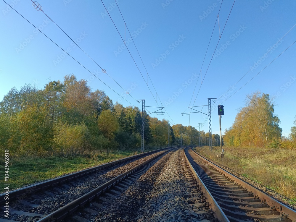 Two way railroad tracks in countryside. Two railway tracks. Sunny day. Countryside. Fields and trees. Two way railroad tracks in countryside. Two railway tracks. Sunny day. Countryside. Fields and trees.