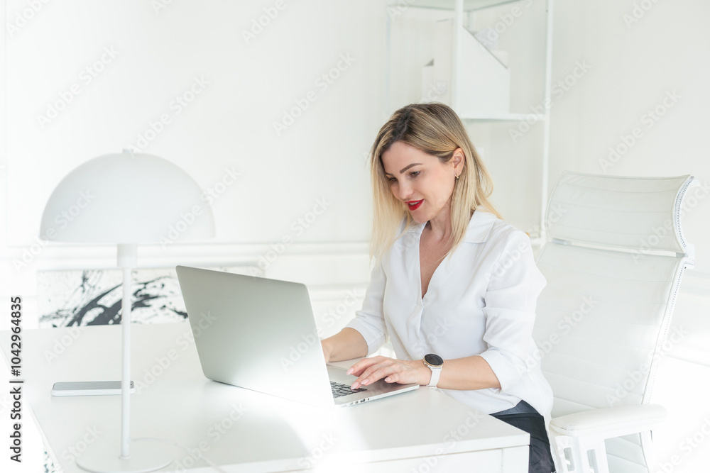 Business woman working on laptop computer at office Business woman working on laptop computer at office