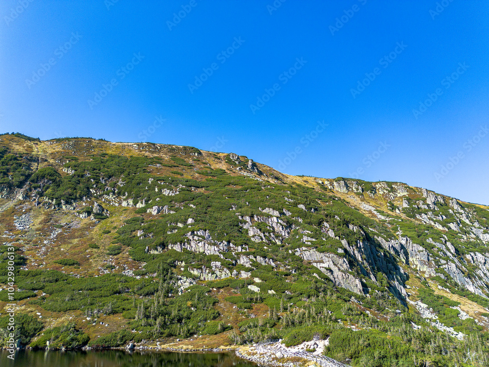 Naklejka premium Panorama of a mountain lake in Poland, Maly Staw and the Krkonose mountain range. Drone view