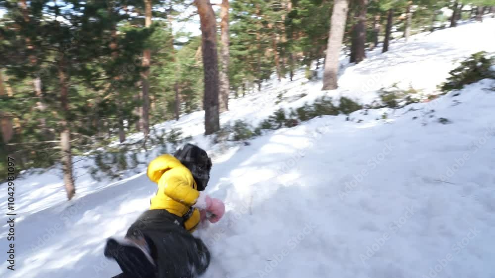 Children playing jump in the snow of a snowy forest on a winter day