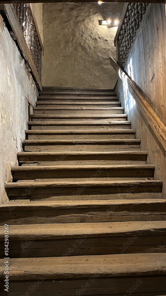 Fototapeta premium Medieval wooden staircase with steps in the castle, view from the inside. Poland