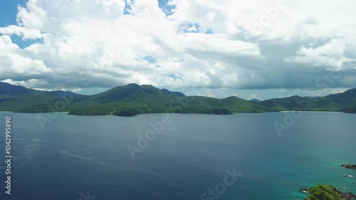 Drone journey from Hen and Chicken Islands back to the lush landscapes of Palawan, capturing dramatic mountain views and ocean expanses.