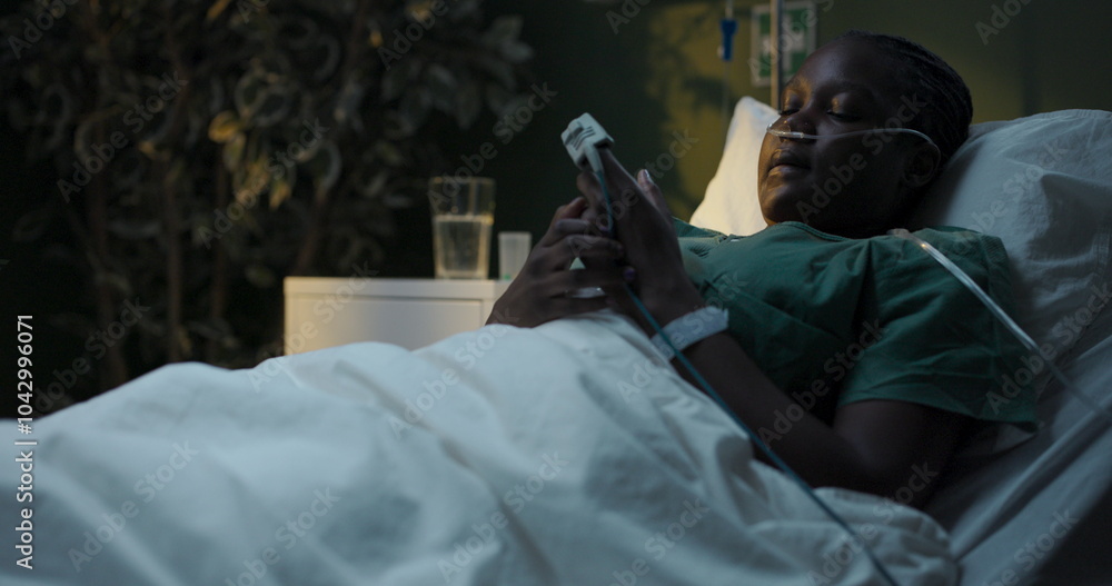 Nervous African patient with oxygen tube stares at hospital ceiling fidgets. Nervous African patient with oxygen tube stares at hospital ceiling fidgets.