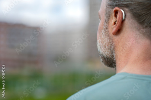 Wallpaper Mural Rear view of man with gray beard wearing hearing aid device Torontodigital.ca