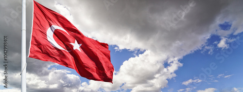 The Turkish flag waving among clouds.      