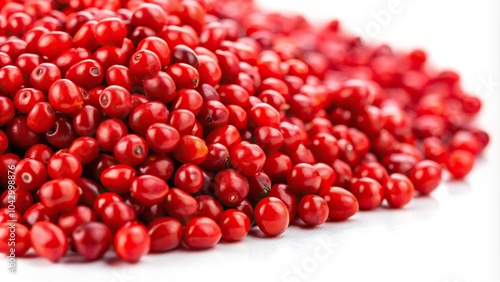 Extreme close-up Ayurvedic plant Adenathera pavonina red seeds isolated on white background photo