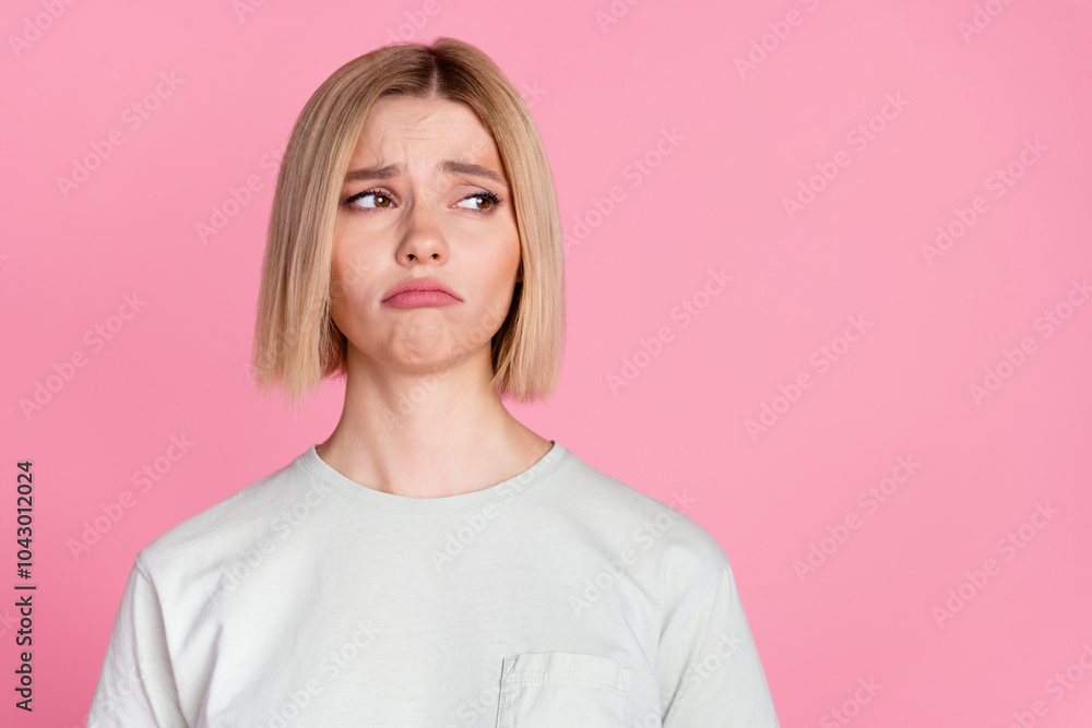 Fototapeta premium Photo of pretty young woman look empty space wear t-shirt isolated on pink color background