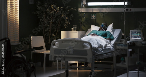 Quadro su tela African woman in an oxygen mask is lying in a hospital room in a serious condition, in a coma, unconscious