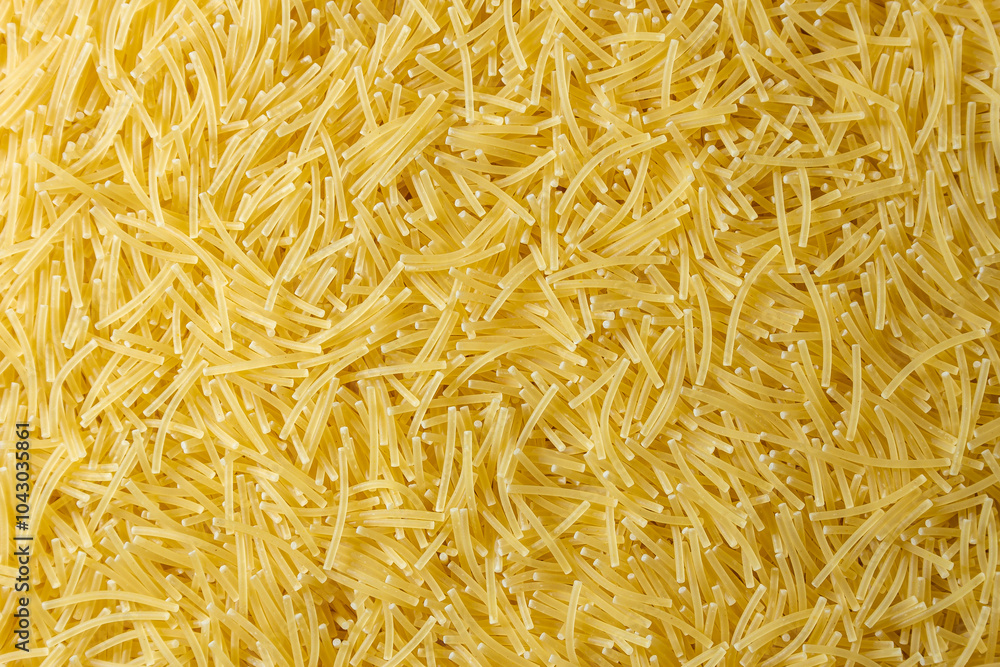Uncooked Filini Pasta: A Culinary Canvas of Noodles, Creating a Lively and Textured Background for Gourmet Cooking. Dry Pasta. Raw Macaroni - Top View, Flat Lay Uncooked Filini Pasta: A Culinary Canvas of Noodles, Creating a Lively and Textured Background for Gourmet Cooking. Dry Pasta. Raw Macaroni - Top View, Flat Lay