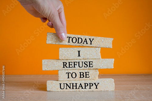 Today I refuse to be unhappy. Concept words Today I refuse to be unhappy on brick blocks. Beautiful orange background, wooden table. Businessman hand. Business psychological concept. photo