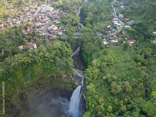 A stunning waterfall and majestic mountain seen from an aerial view