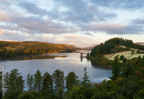 Early morning light on t he lake, with forest surrounding it.