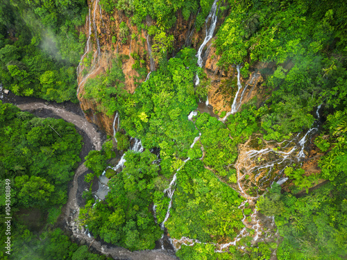 Aerial view of a magnificent waterfall in a lush forest