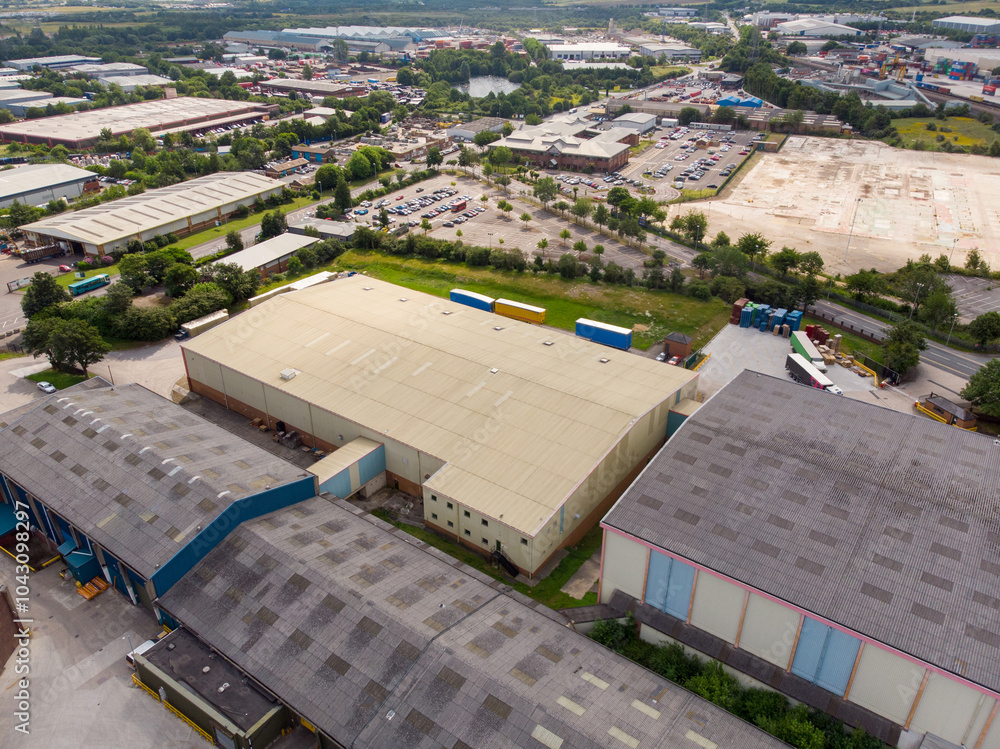 Aerial drone photo of a large warehouse and storage unit located in the town of Hunslet in the city of Leeds in West Yorkshire in the UK showing the large distribution site and roads from above