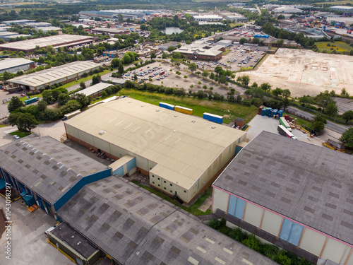 Obraz na płótnie Aerial drone photo of a large warehouse and storage unit located in the town of Hunslet in the city of Leeds in West Yorkshire in the UK showing the large distribution site and roads from above w salonie