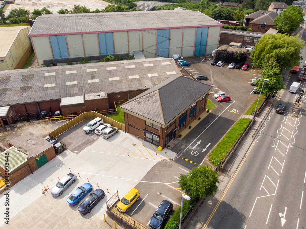 Aerial drone photo of a large warehouse and storage unit located in the town of Hunslet in the city of Leeds in West Yorkshire in the UK showing the large distribution site and roads from above