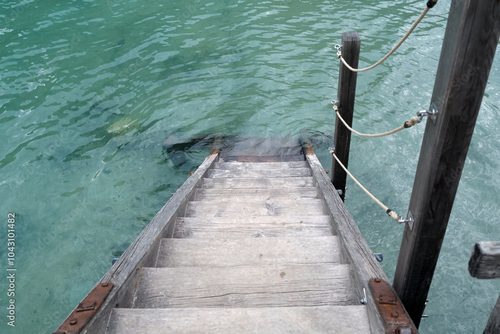 Fototapeta premium Wooden stairs to clear lake