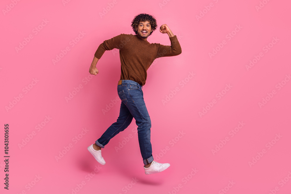 Photo of good mood positive glad man wear stylish brown clothes hurry empty space isolated on pink color background Photo of good mood positive glad man wear stylish brown clothes hurry empty space isolated on pink color background