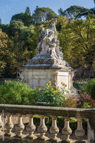 Scenic vertical landscape view of the main statue of the nymphaeum or nymphée in Jardins de la Fontaine park, Nîmes, Gard, France photo