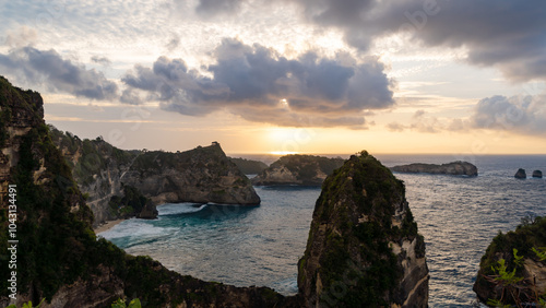 Experience the breathtaking beauty of a sunset casting vibrant hues over a rocky coastline