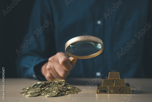 Businessman using magnifier and decide between gold and money coin for stock market fund currency wealth investment and financial concept.