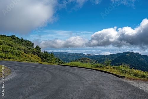 A winding road leads through a mountain pass with stunning views.