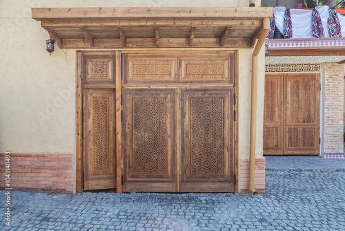 modern carved wooden gate with Islamic Uzbek carved pattern with stars ornament in oriental style in Uzbekistan in Tashkent photo