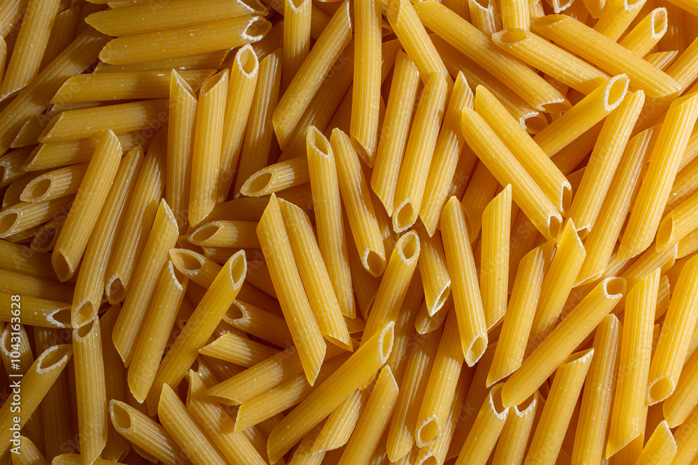 Uncooked Penne Rigate Pasta: A Culinary Canvas of Penne Macaroni, Creating a Lively and Textured Background for Gourmet Cooking. Dry Pasta. Raw Macaroni - Top View, Flat Lay Uncooked Penne Rigate Pasta: A Culinary Canvas of Penne Macaroni, Creating a Lively and Textured Background for Gourmet Cooking. Dry Pasta. Raw Macaroni - Top View, Flat Lay