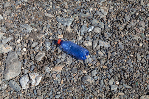 A carelessly discarded plastic water bottle. Plastic waste in nature. A global environmental problem. photo