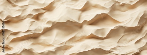 A textured surface resembling crumpled fabric or paper in neutral tones.