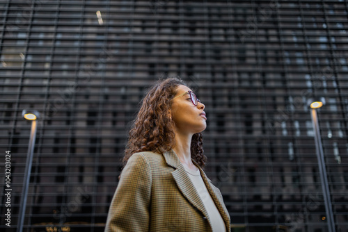 Brazilian businesswoman in urban setting looks confidently ahead
