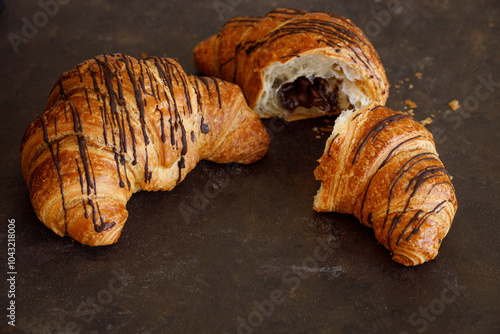 Croissant with butter two pieces on a black board. High quality photo
