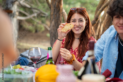 Young woman enjoying outdoor picnic food happiness natural lifestyle authentic smile summer dining