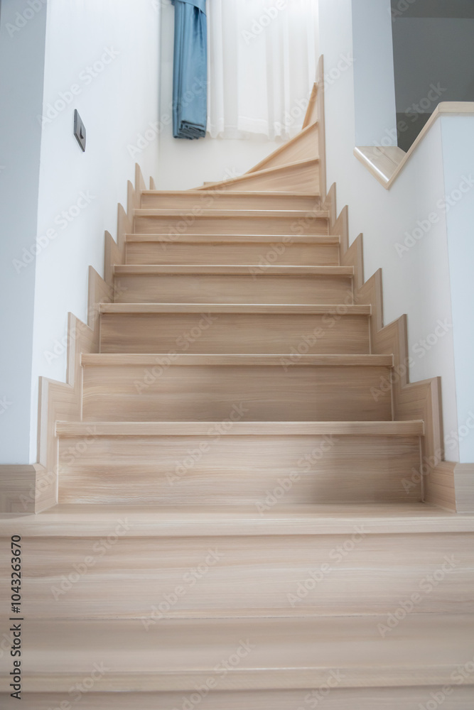A modern, light-toned wooden staircase inside a contemporary home A modern, light-toned wooden staircase inside a contemporary home