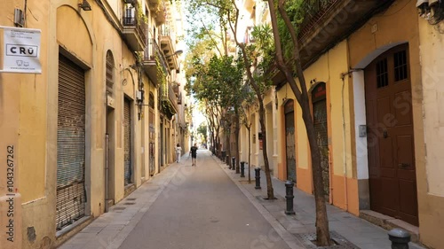 Walking down a street in Barcelona in the neighborhood of Gracia, Catalonia, Spain.  Moving shot.