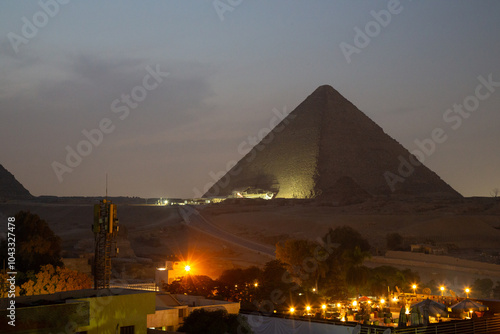 Great Pyramid complex enlighted at night, Giza, Egypt photo