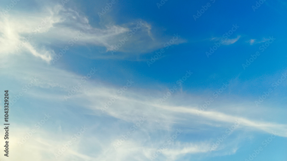 Fototapeta premium The blue sky is decorated with dense clouds that spread out on a sunny day. Sky background. Nature Background.