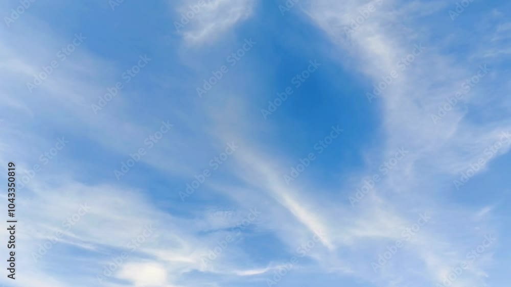 White clouds flying across the clear blue sky. Clear sky during the day. Background view of clouds moving in the wind. Copy space White clouds flying across the clear blue sky. Clear sky during the day. Background view of clouds moving in the wind. Copy space