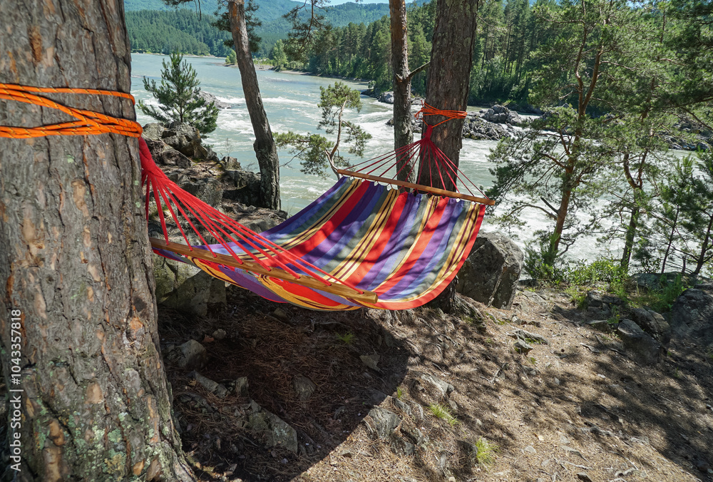 Beautiful landscape with hammock in the summer sunny day. Against the background of a mountain river.
A gently swinging hammock tied between two trees. Concept for relaxation, rural tourism Beautiful landscape with hammock in the summer sunny day. Against the background of a mountain river.
A gently swinging hammock tied between two trees. Concept for relaxation, rural tourism