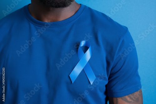 Man wearing t-shirt with blue ribbon symbolizing prostate cancer awareness month