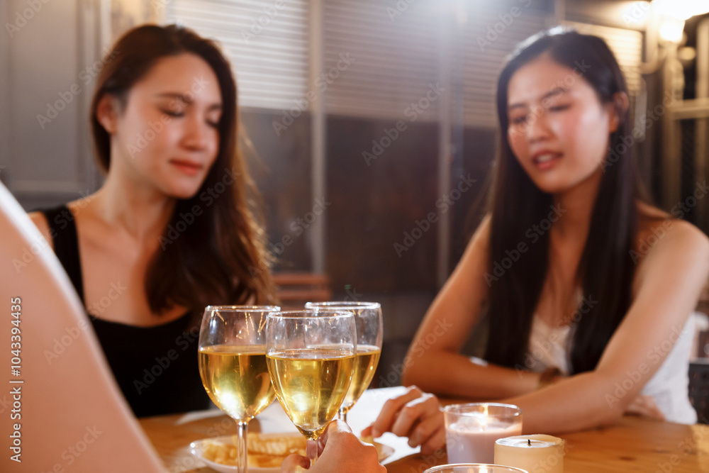 happy group of asian woman teenagers cheering and toast with white sparkling wine glass to celebrating at dinner party. celebration, relationship and friendship concept. happy group of asian woman teenagers cheering and toast with white sparkling wine glass to celebrating at dinner party. celebration, relationship and friendship concept.