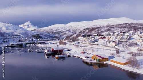 Aerial drone view of fishing boat in the port of northern Norway, Tromso. Sunny winter day