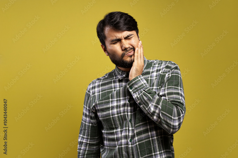 man feeling pain in his tooth and with his hand on his face man feeling pain in his tooth and with his hand on his face