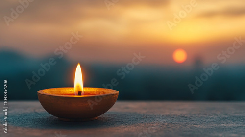 The serene glow of a diya at sunset a symbol of hope and light in a chaotic world photo