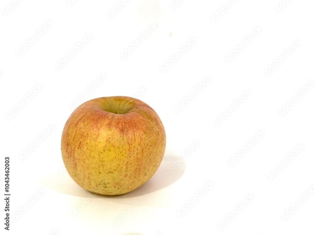 A single fresh apple fruit with red and yellow color and stripes pattern isolated on white background A single fresh apple fruit with red and yellow color and stripes pattern isolated on white background