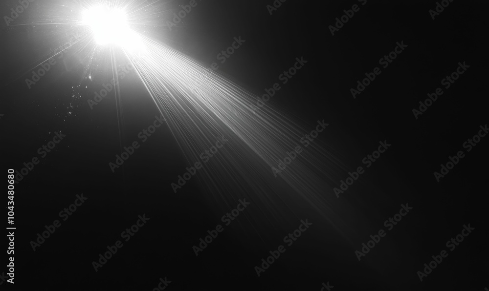 A single bright light ray against a black background. A single bright light ray against a black background.
