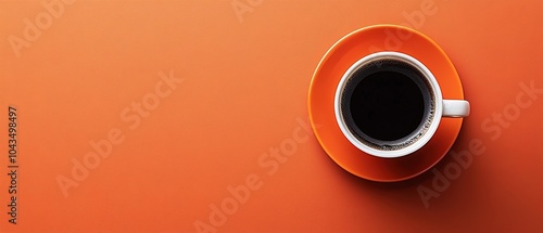 Orange Coffee Cup with Black Coffee Against Textured Background